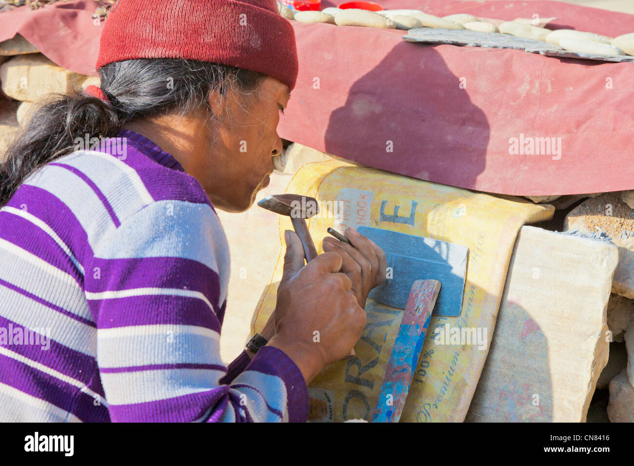 Tibetan carving mantras on stones under Swayambhunath Stupa, Kathmandu, Nepal Stock Photo