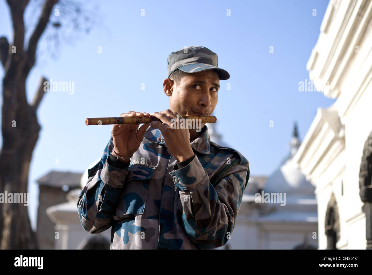 Nepal army man playing flute during Shivaratri festival at  Pashupatinath temple , Kathmandu Stock Photo