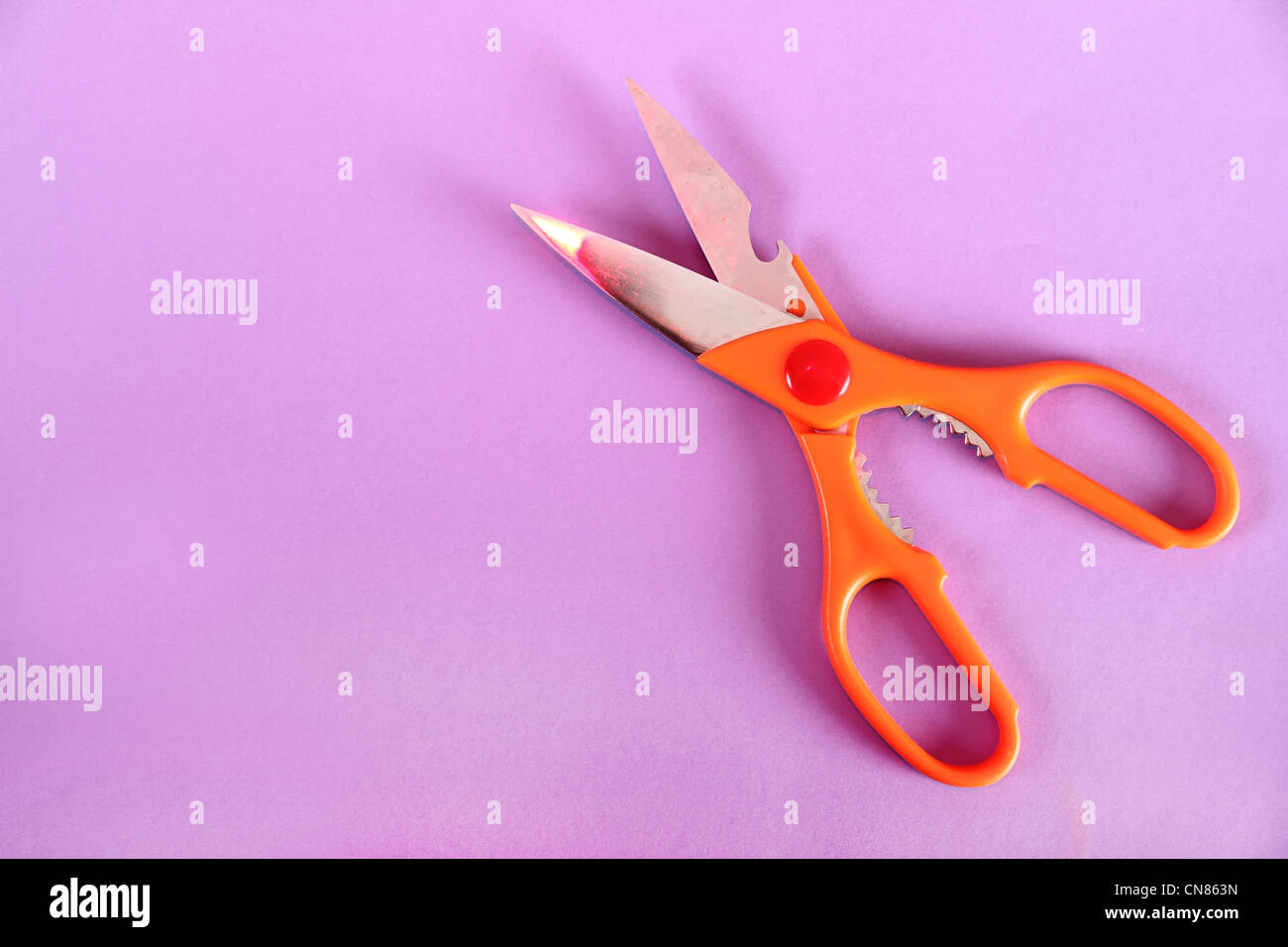 A Scissor on a purple paper background Stock Photo - Alamy
