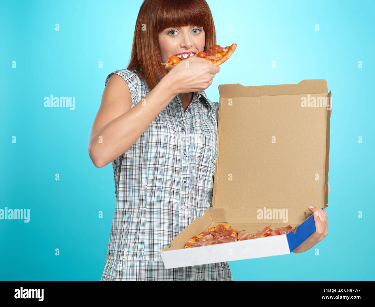 beautiful-young-woman-eating-a-pizza-pie-from-the-delivery-box-smiling-CN87W7.jpg