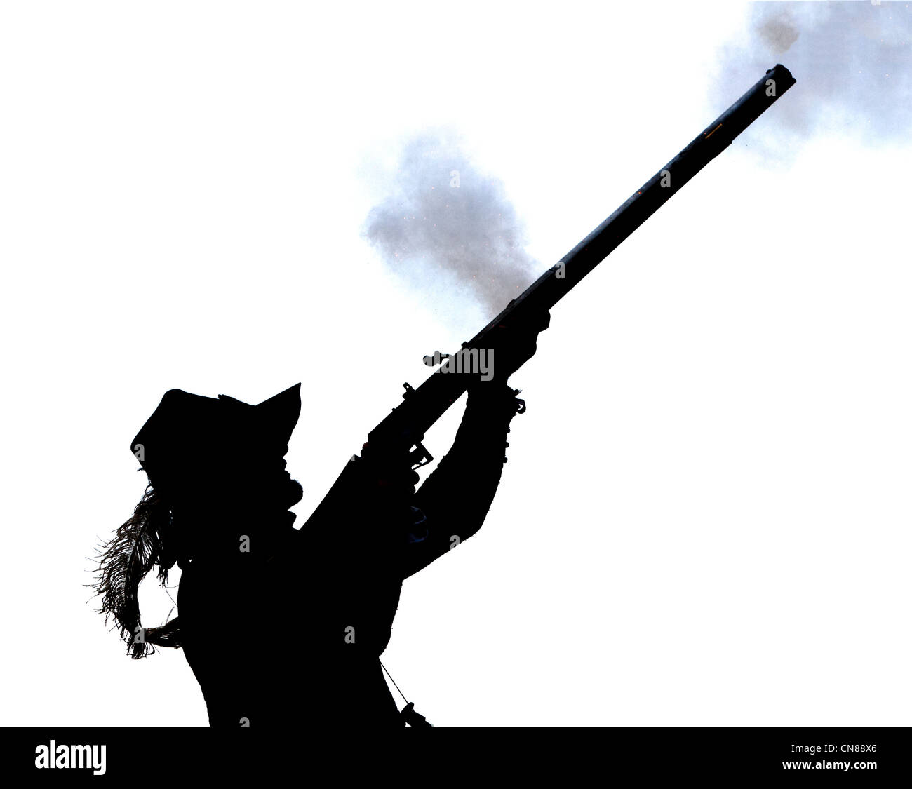Silhouette of man stooting rifle Stock Photo