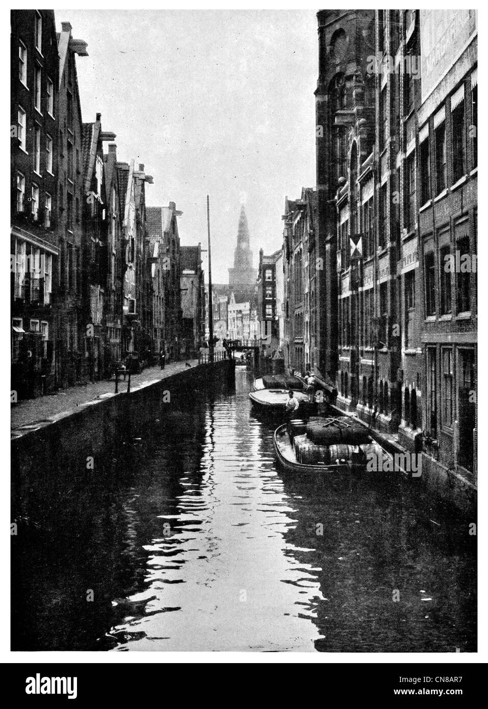 First published 1915 Old Amsterdam Warehouse trade cargo merchant quarter canal barge narrow boat Stock Photo