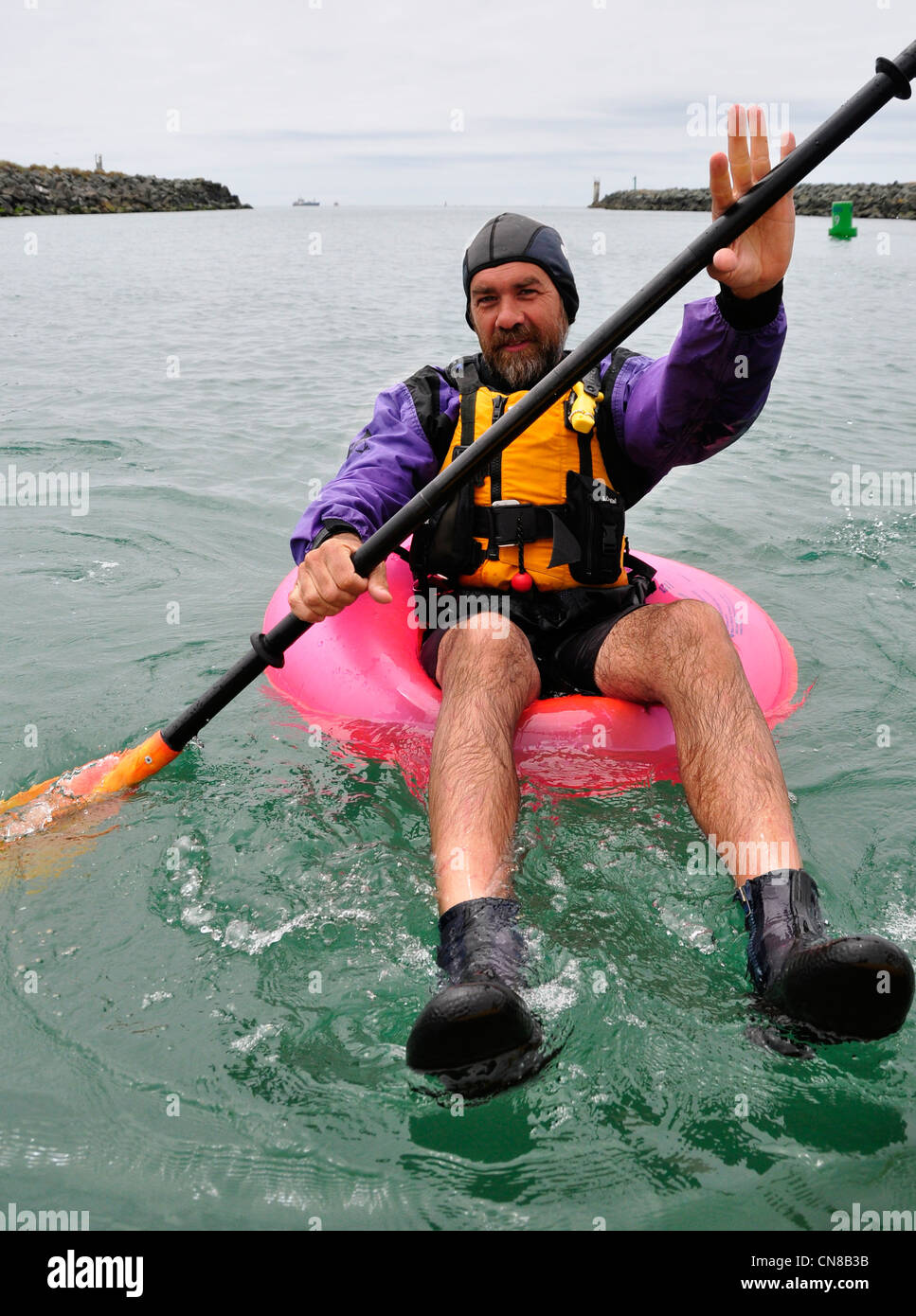 Floating on a toy inner tube at the mouth of the Chetco River in Brookings, Oregon. Stock Photo