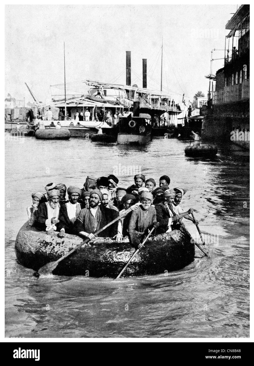 First published 1914  Steam ship goofah boat basket coracle Baghdad ferry Stock Photo