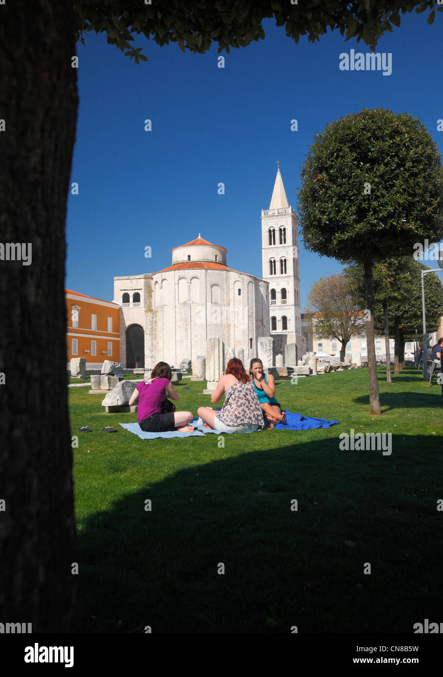Tourists relax at Forum in Zadar. Church of st. Donatus on the back. Stock Photo