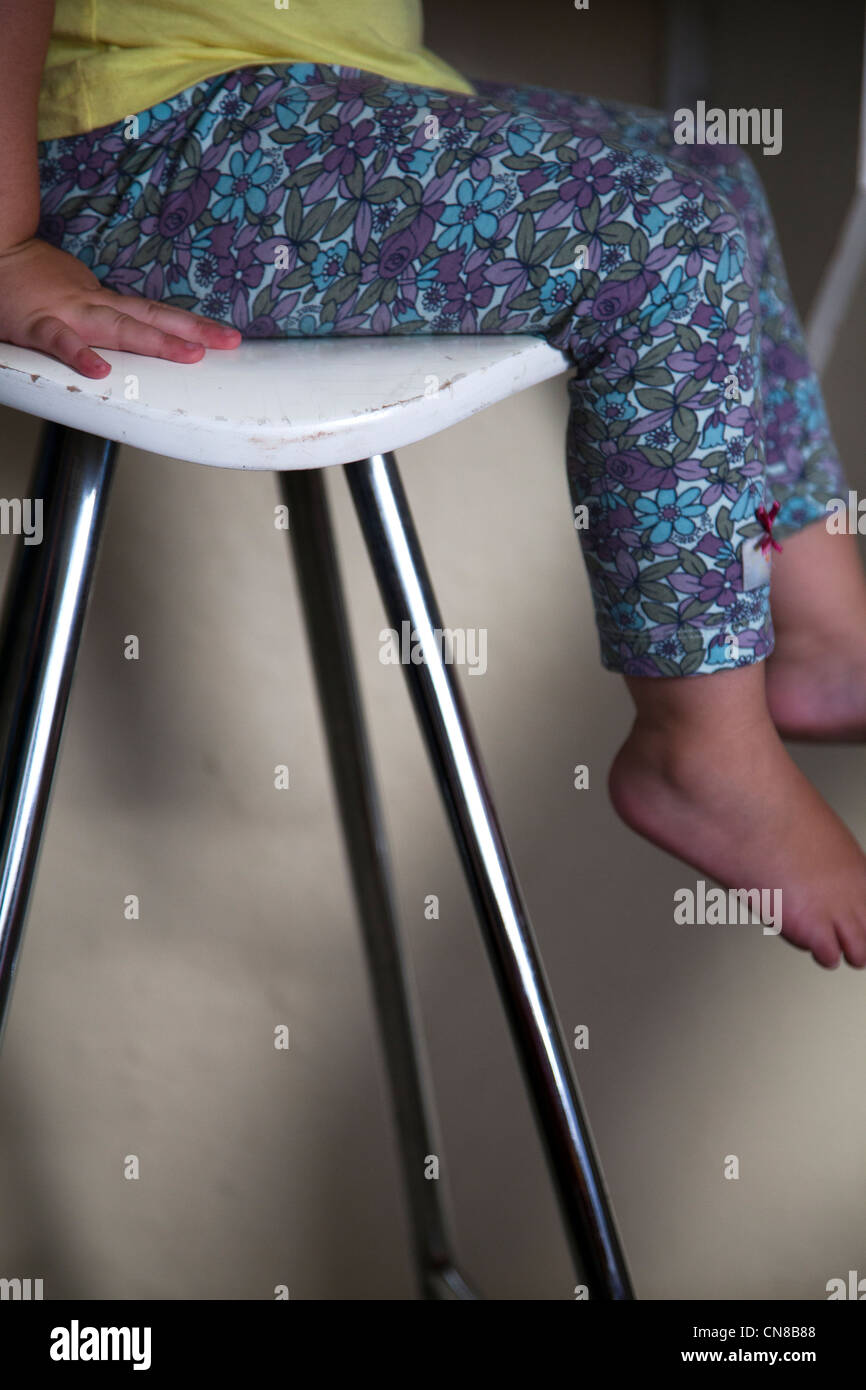 Girls legs hanging off stool Stock Photo Alamy
