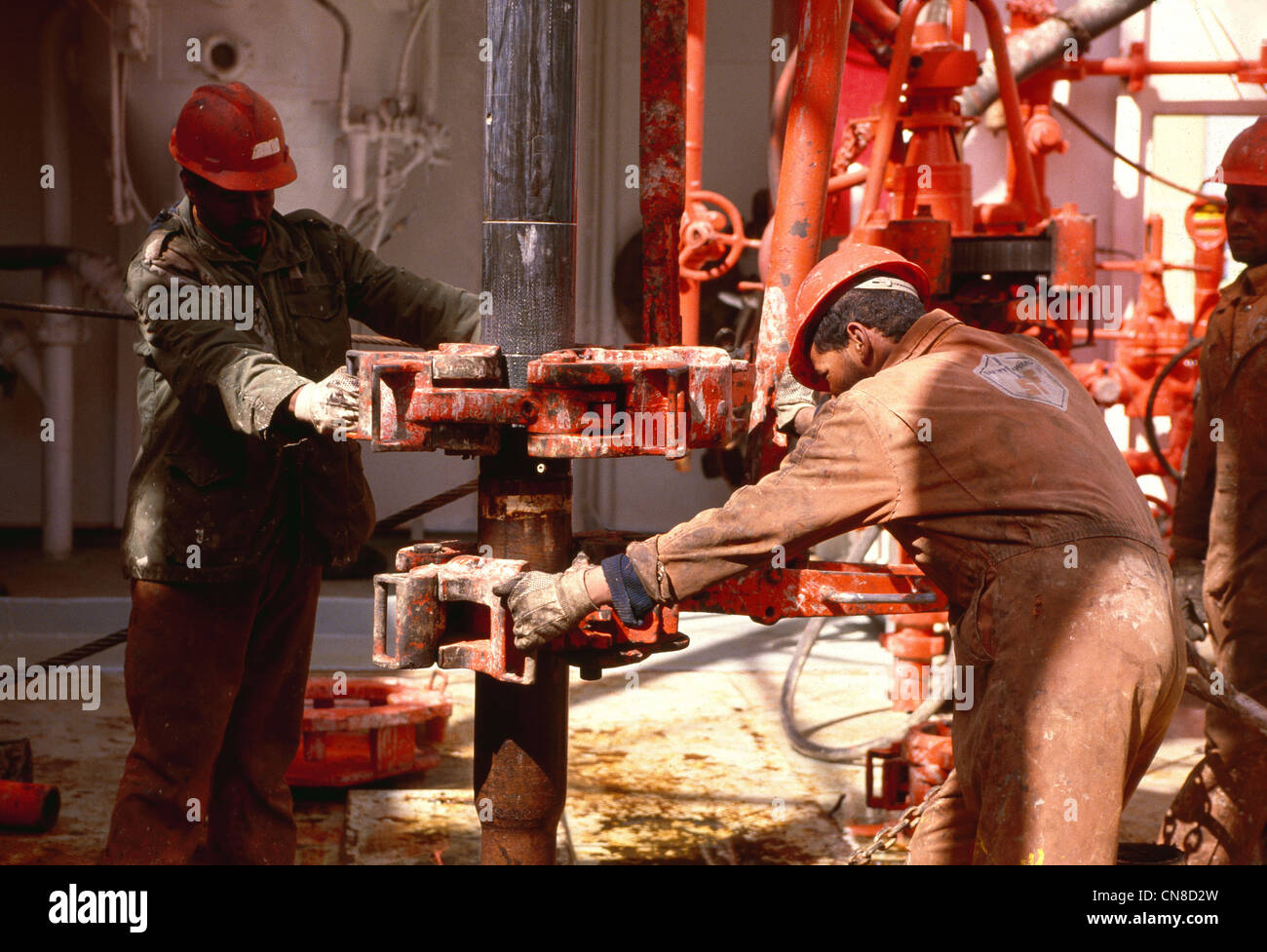Roughneck action with drill pipe on the rig floor of an offshore