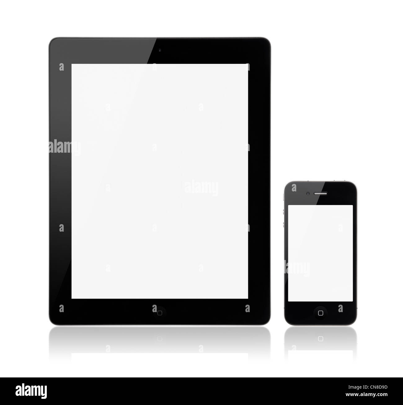 A new Apple iPad 3rd generation with Apple iPhone 4S on a white background with a blank screen. Stock Photo