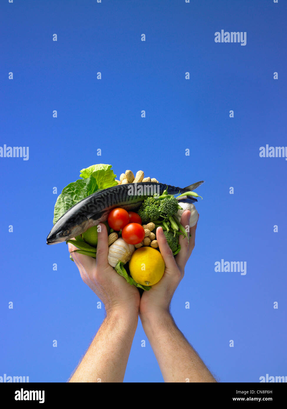 Hands holding up healthy foods Stock Photo
