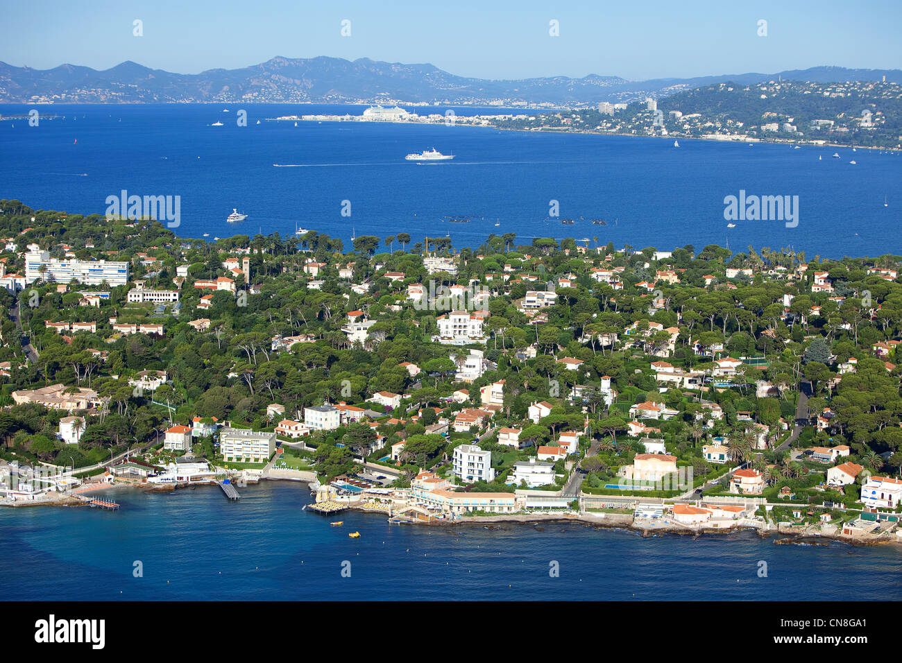 France, Alpes Maritimes, Antibes, Cap d'Antibes, Cannes in the background (aerial view) Stock Photo