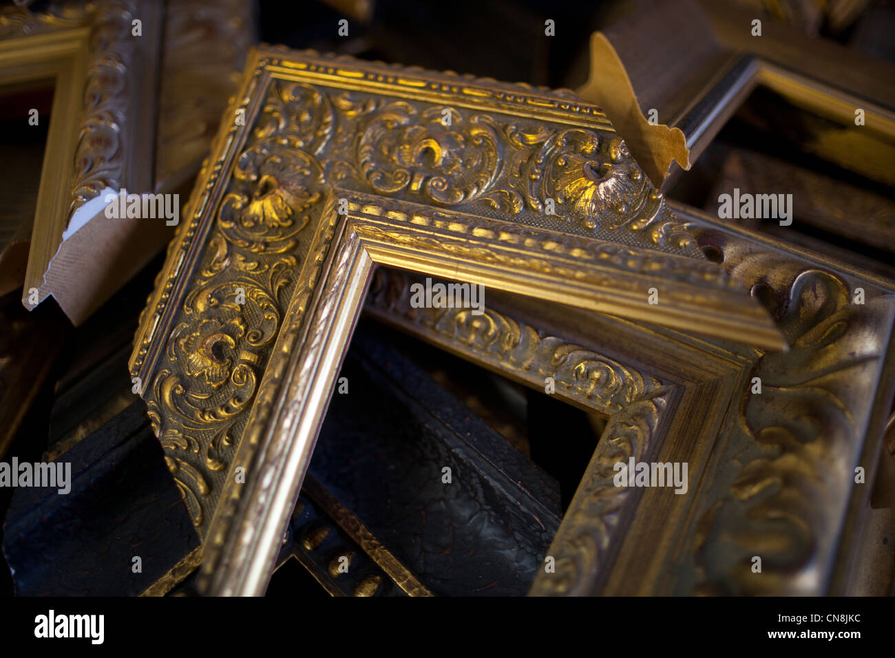 Samples of ornate wooden picture frames lie on a table in New York City