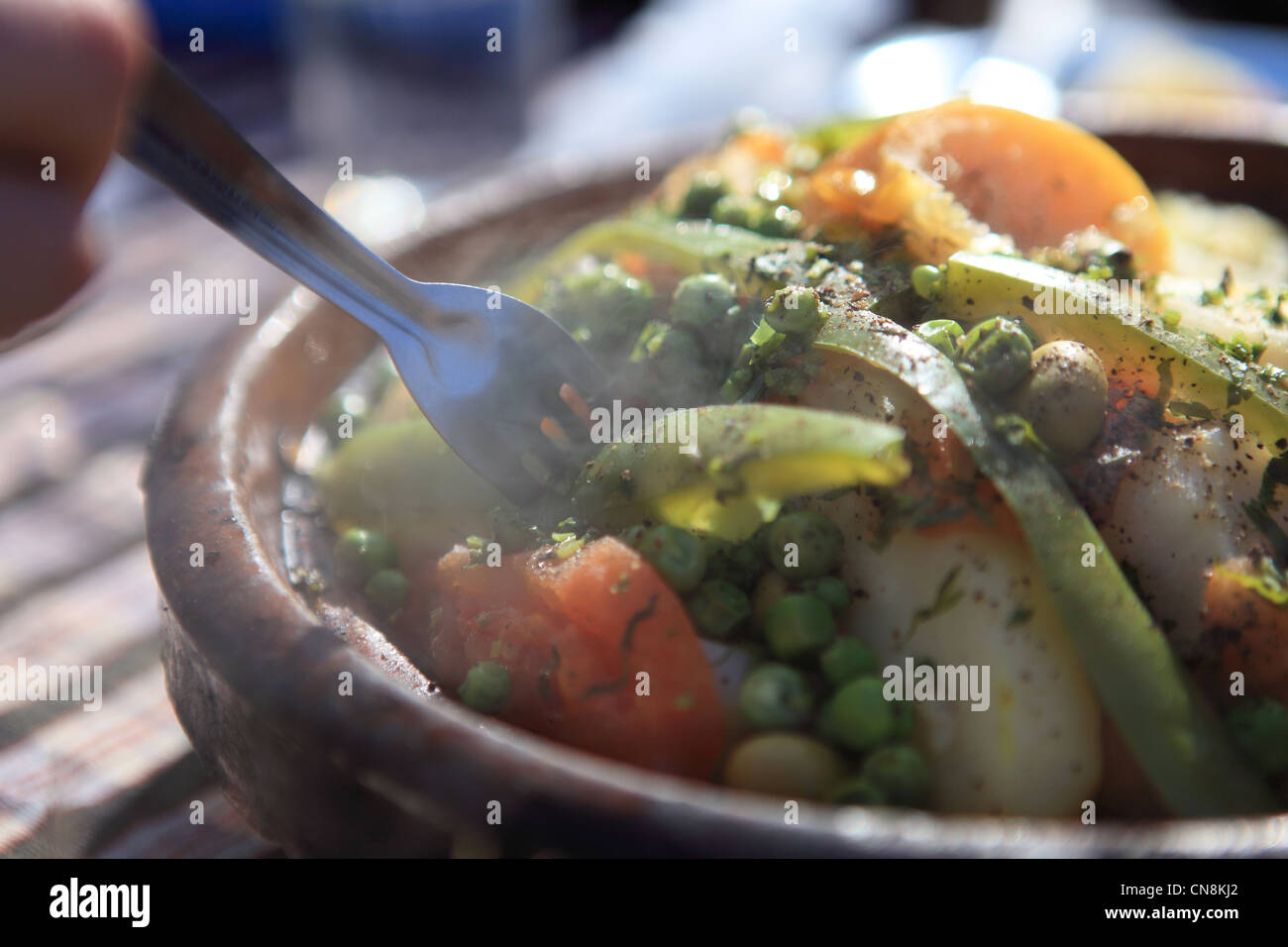 Traditional Moroccan vegetable tagine served outdoors in a restaurant