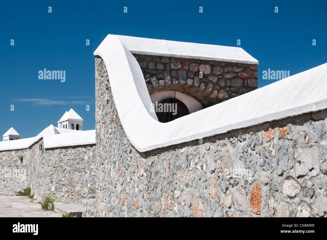 Stone wall and chimneys- architecture detail- Hydra island, Greece Stock Photo