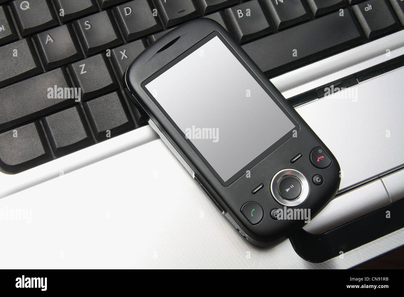 Smart Phone on Laptop Computer Stock Photo - Alamy