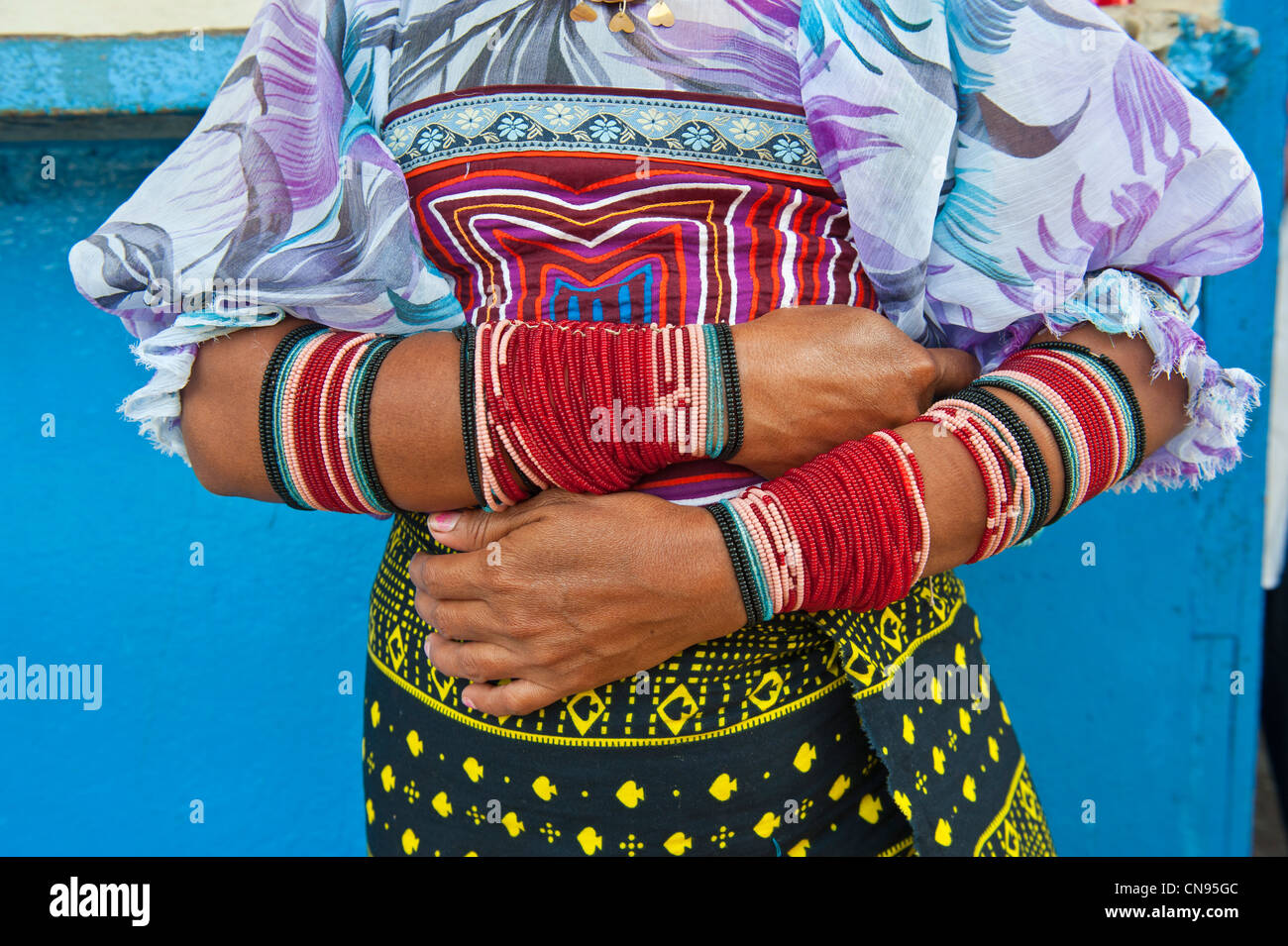 Panama, San Blas archipelago, Kuna Yala autonomous territory, Carti island, Kuna indian showing off her bracelets and molas Stock Photo