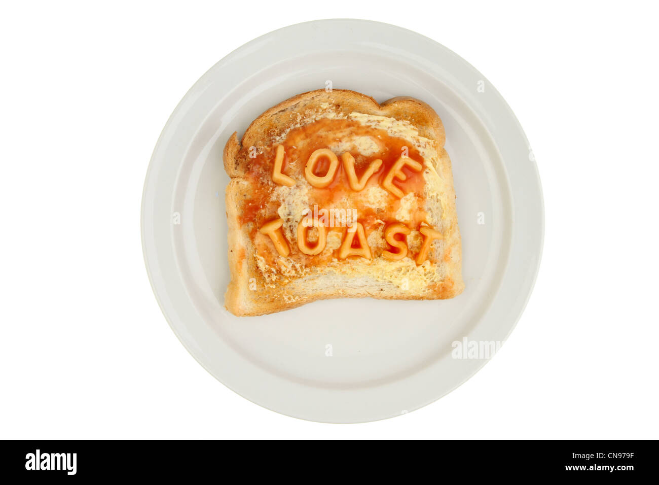 Alphabet spaghetti on toast on a plate spells love toast Stock Photo