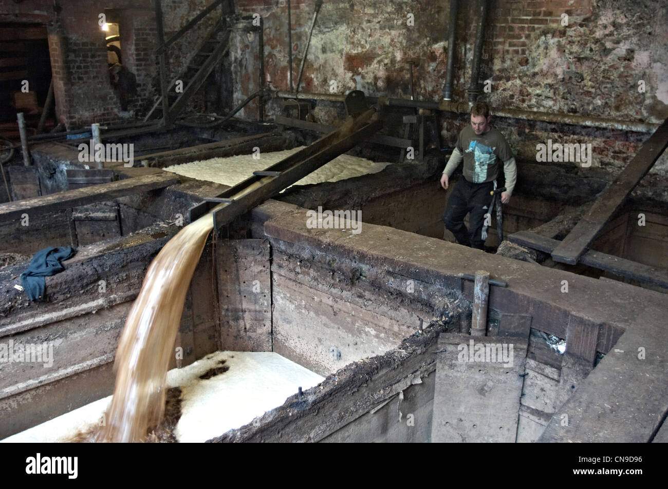 Mixing the liquor for traditional oak bark tanning at Bakers Tannery Colyton Devon England Stock Photo