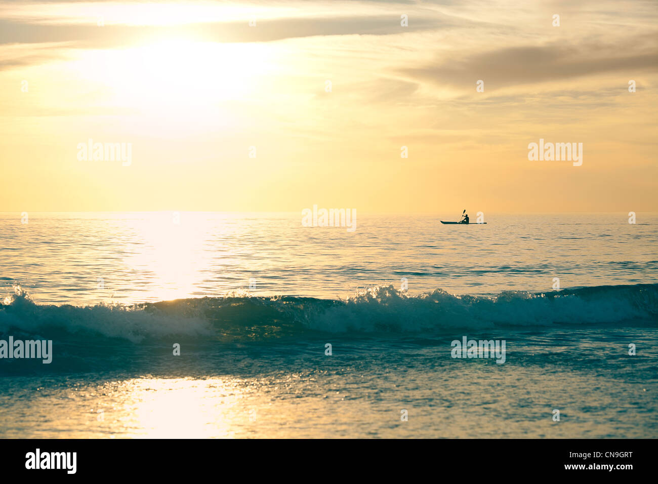 Man in a canoe on the ocean Stock Photo - Alamy