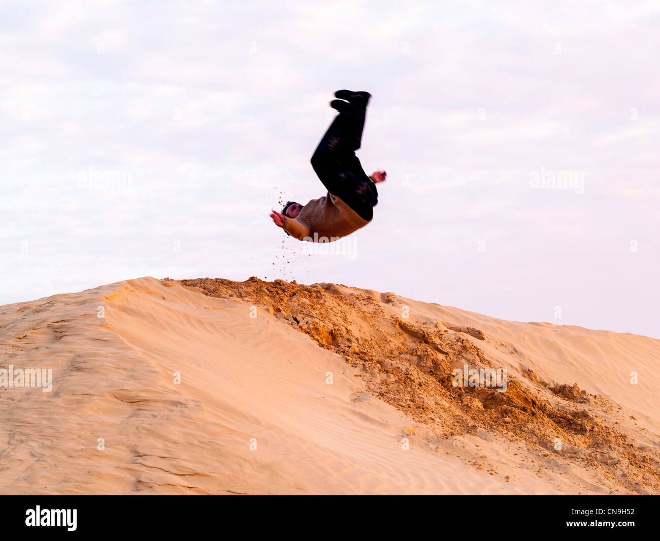 Man jump in the dunes Stock Photo Alamy
