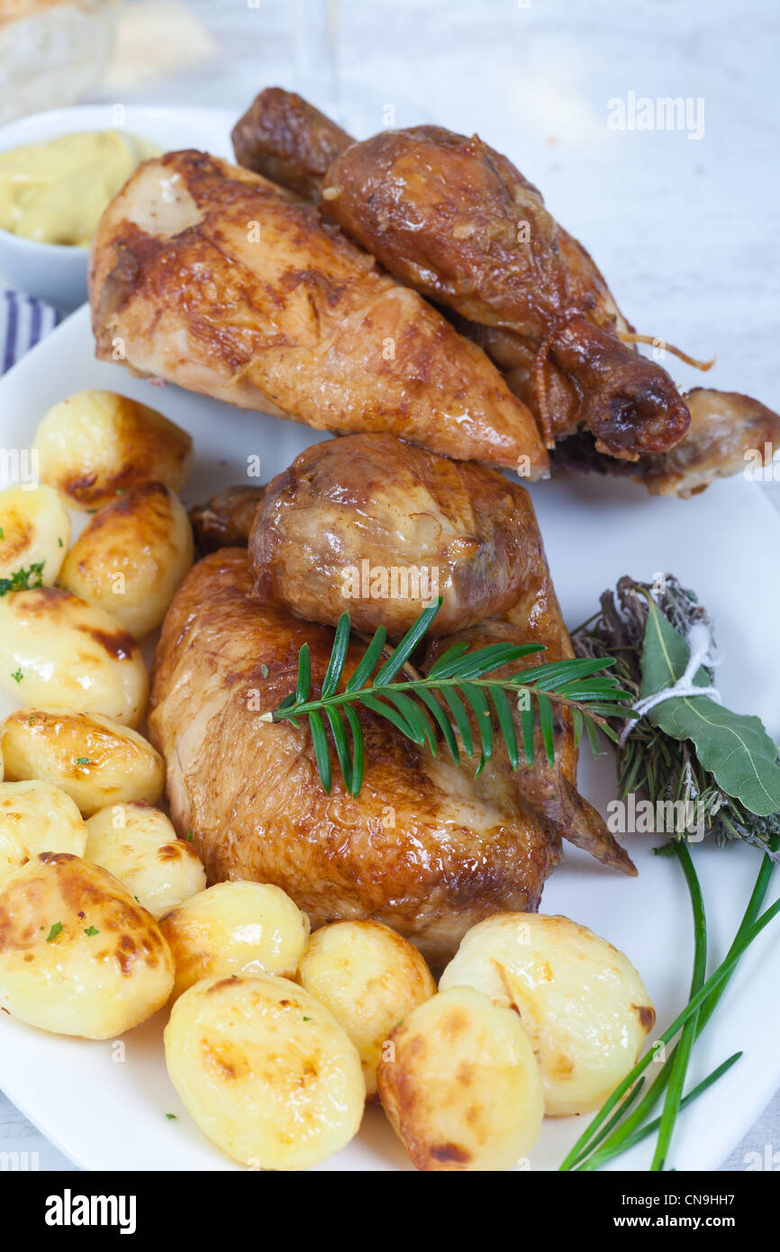 Tasty chicken with roasted potatoes Stock Photo - Alamy