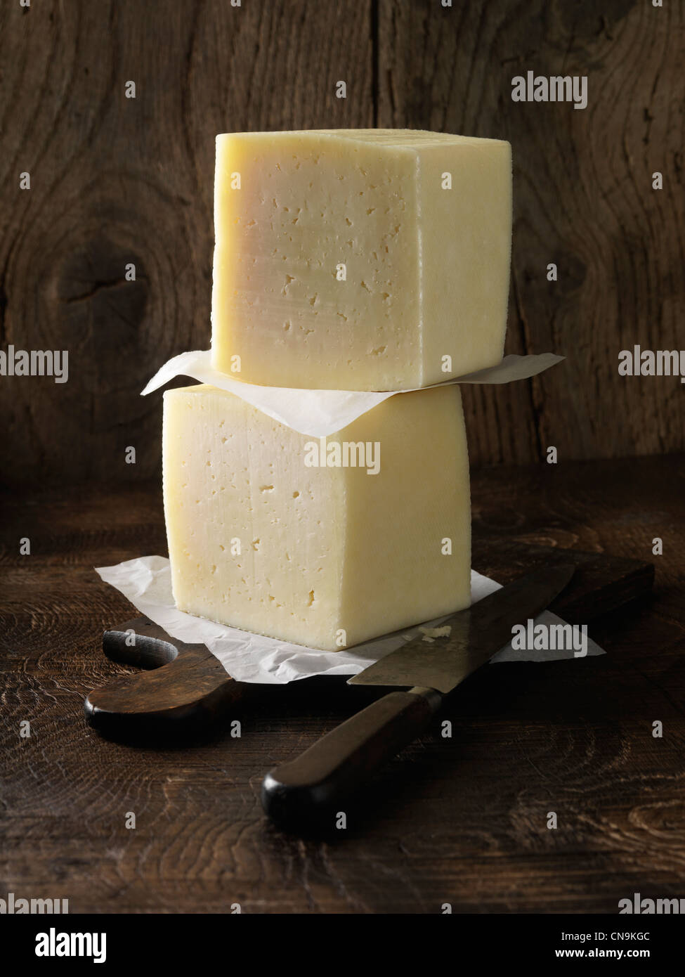 Manchego cheese on wooden board Stock Photo Alamy