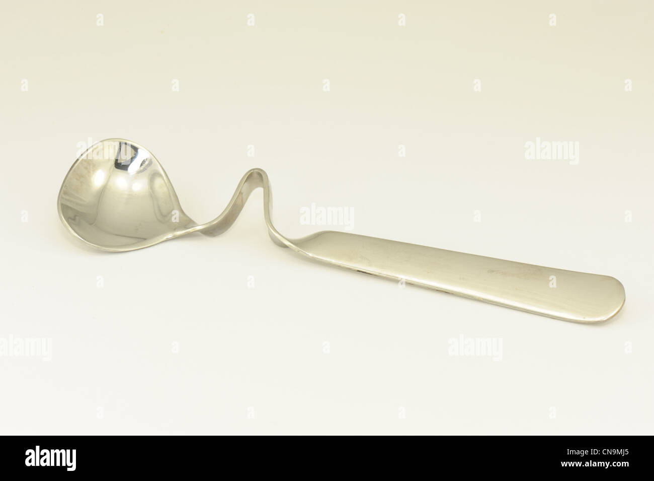 spoon honey spoon designed to rest on jar after use taken on a white