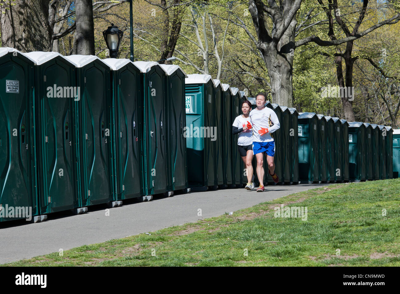 A line of portable toilets, conveniently placed for the starting line of a race, are seen in Central Park in New York Stock Photo
