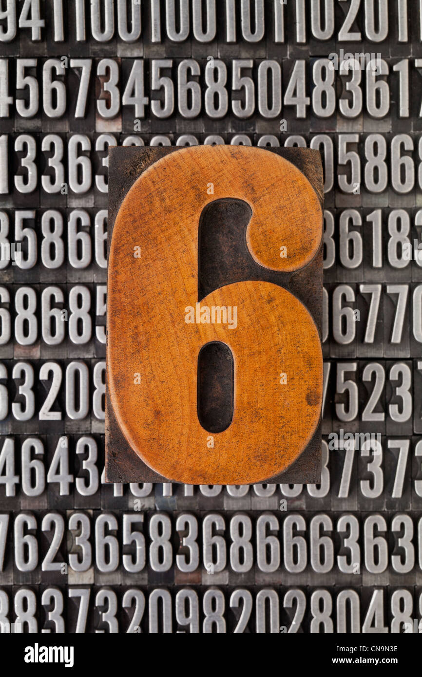 number six in vintage letterpress wood type against background of random metal numbers Stock Photo