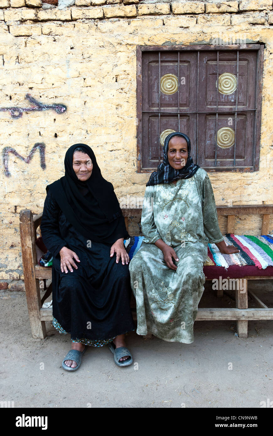 Two egyptian women sitting on a bench - Luxor, Upper Egypt Stock Photo