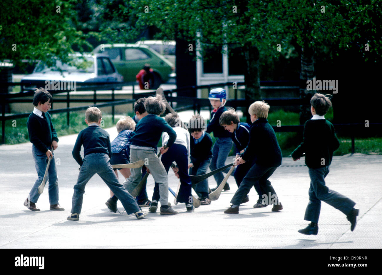 School boys at a Limerick junior school play at hurling during lunch break IRELAND Stock Photo