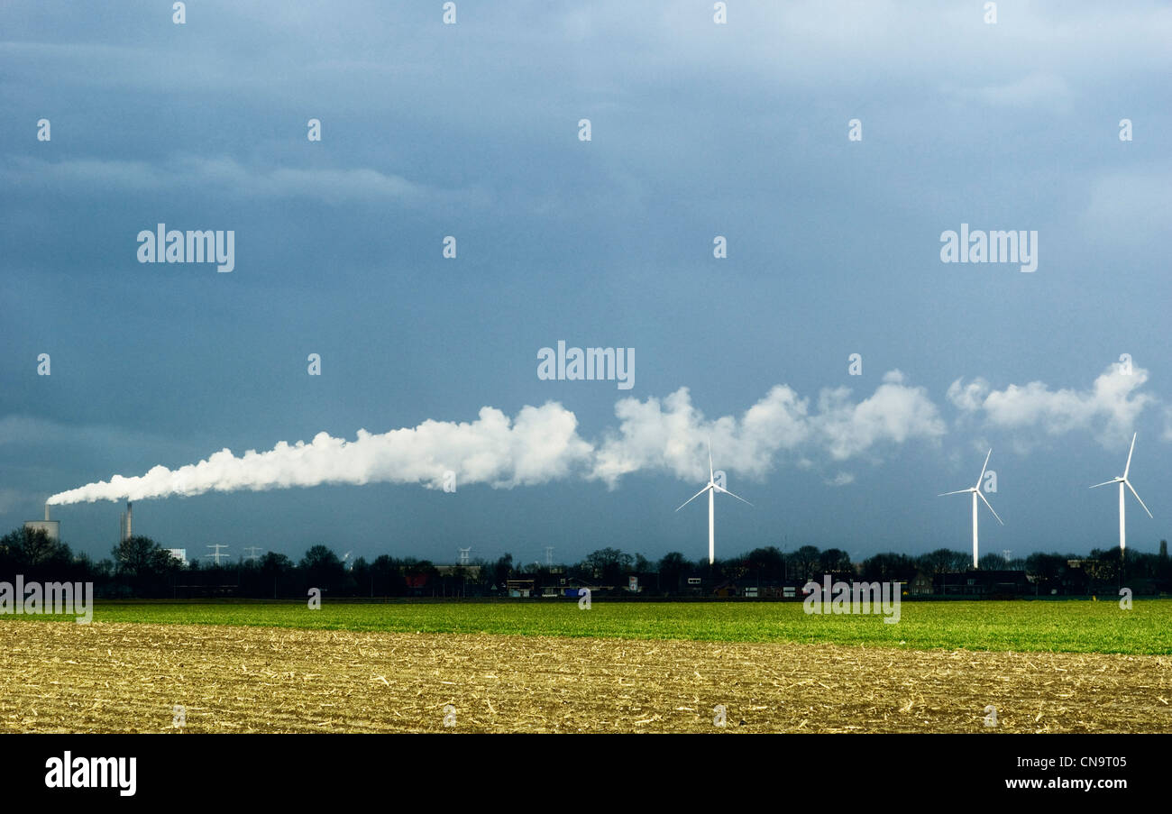 Wind turbines and factory smoke Stock Photo