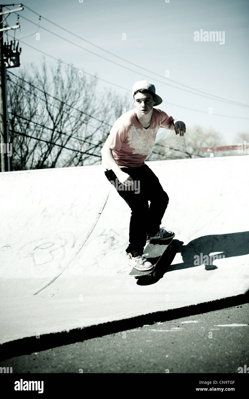 Portrait of a young skateboarder skating down a ramp Stock Photo - Alamy