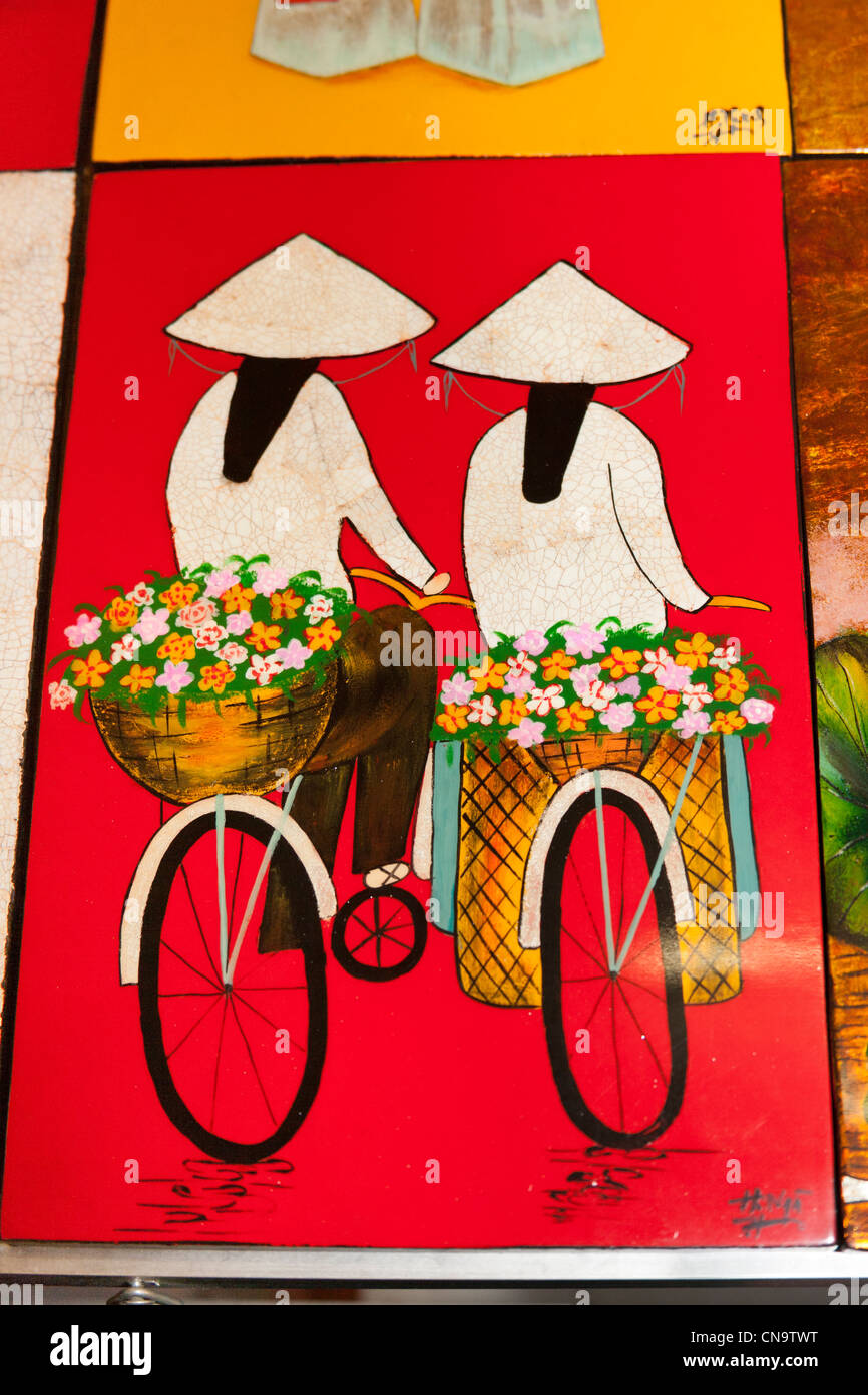 Colourful painting of two Vietnamese women riding bicycles, Vietnam Stock Photo