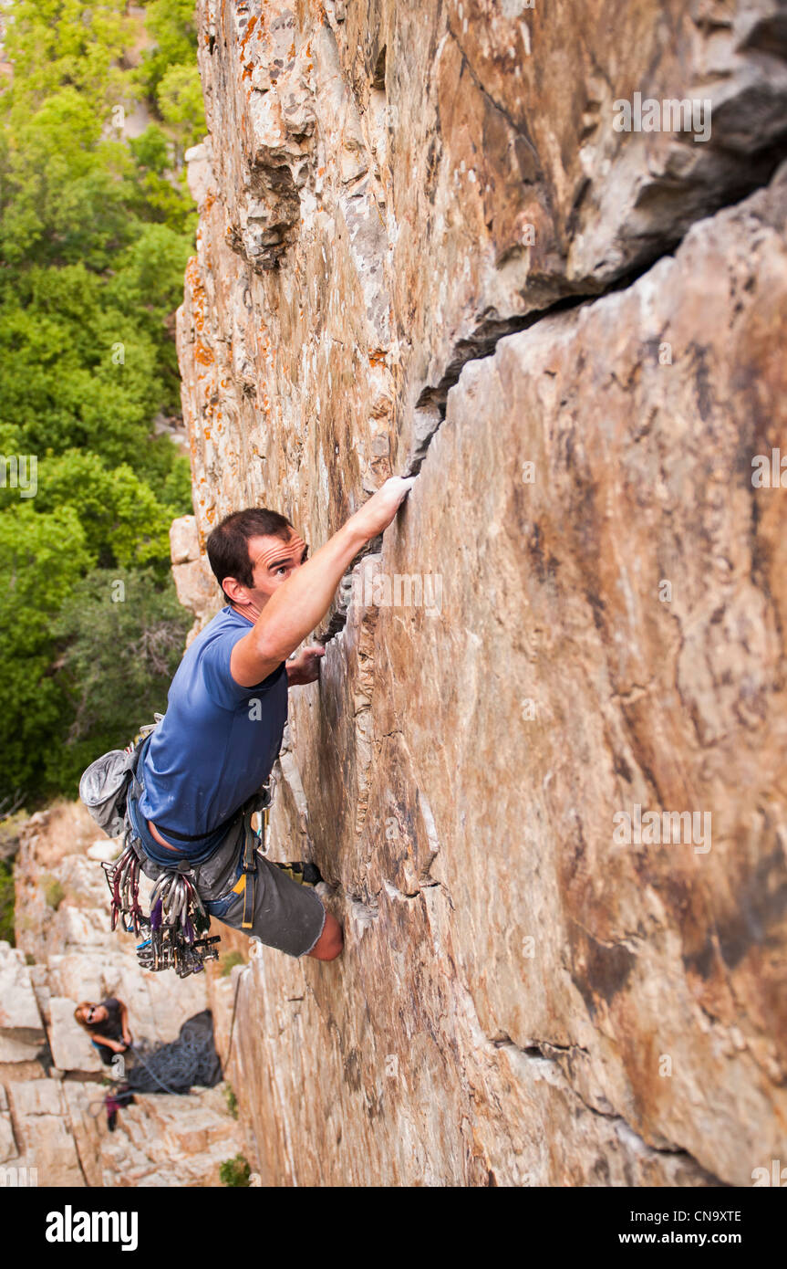 Man hanging from climbing wall hi-res stock photography and images - Alamy