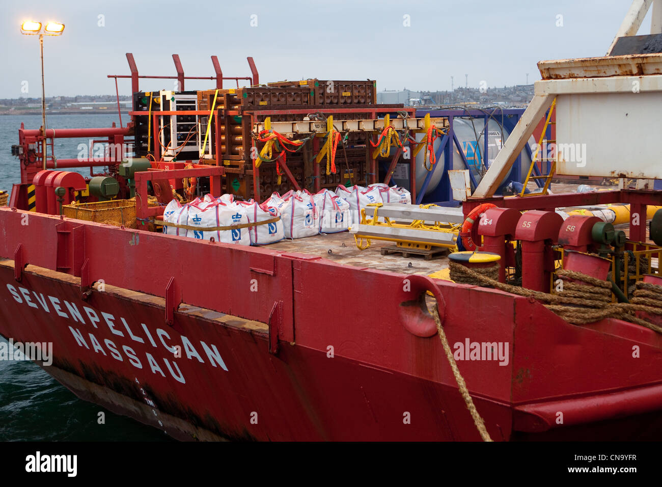 Oil supply vessel loading cargo for North sea oil rigs at Peterhead ...