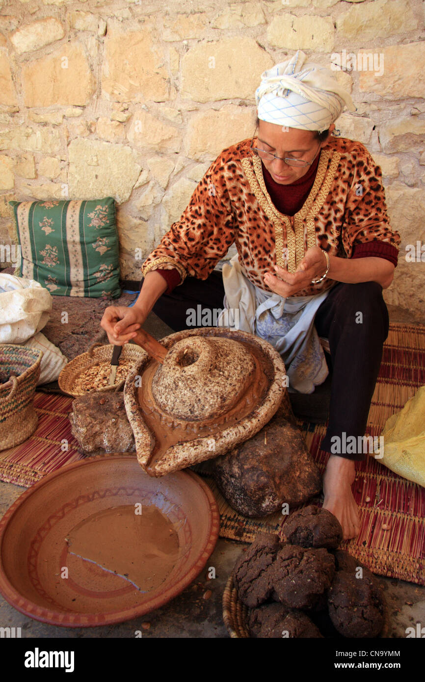 Berber woman extracting oil from Argan nut kernals at Assous Argan oil co-operative, Souss Valley,  Morocco, north Africa Stock Photo