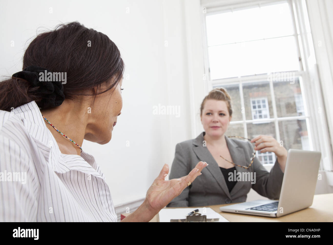 Businesswomen working together in office Stock Photo - Alamy