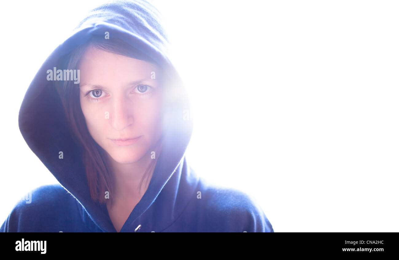 portrait of a pretty young woman wearing a blue hoodie on glowing ...