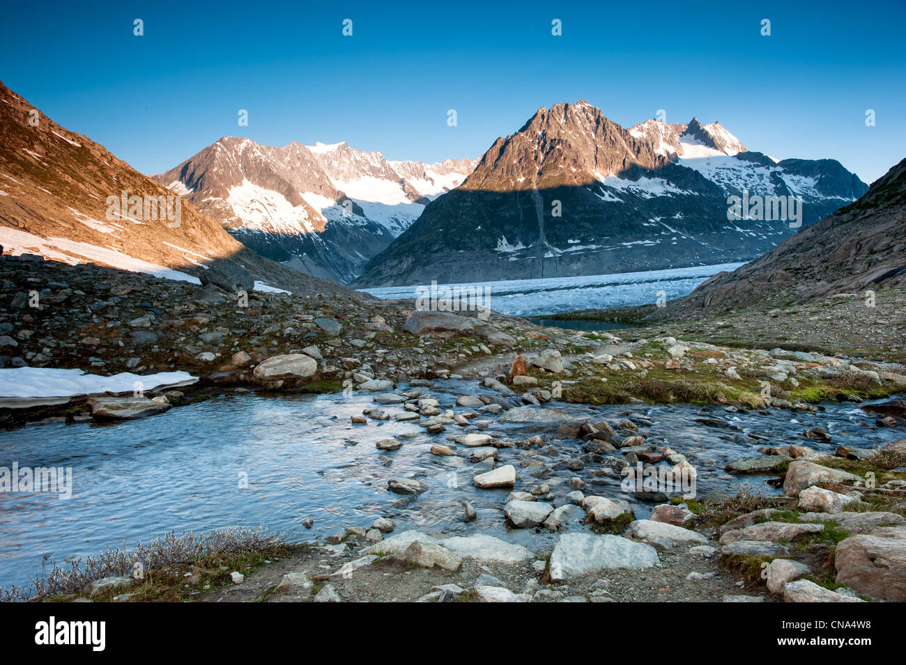 Panorama from Maerjelensee in early morning with Fusshorn and Dreieckshorn. Part of the Jungfrau-Aletsch UNESCO World Heritage, Stock Photo