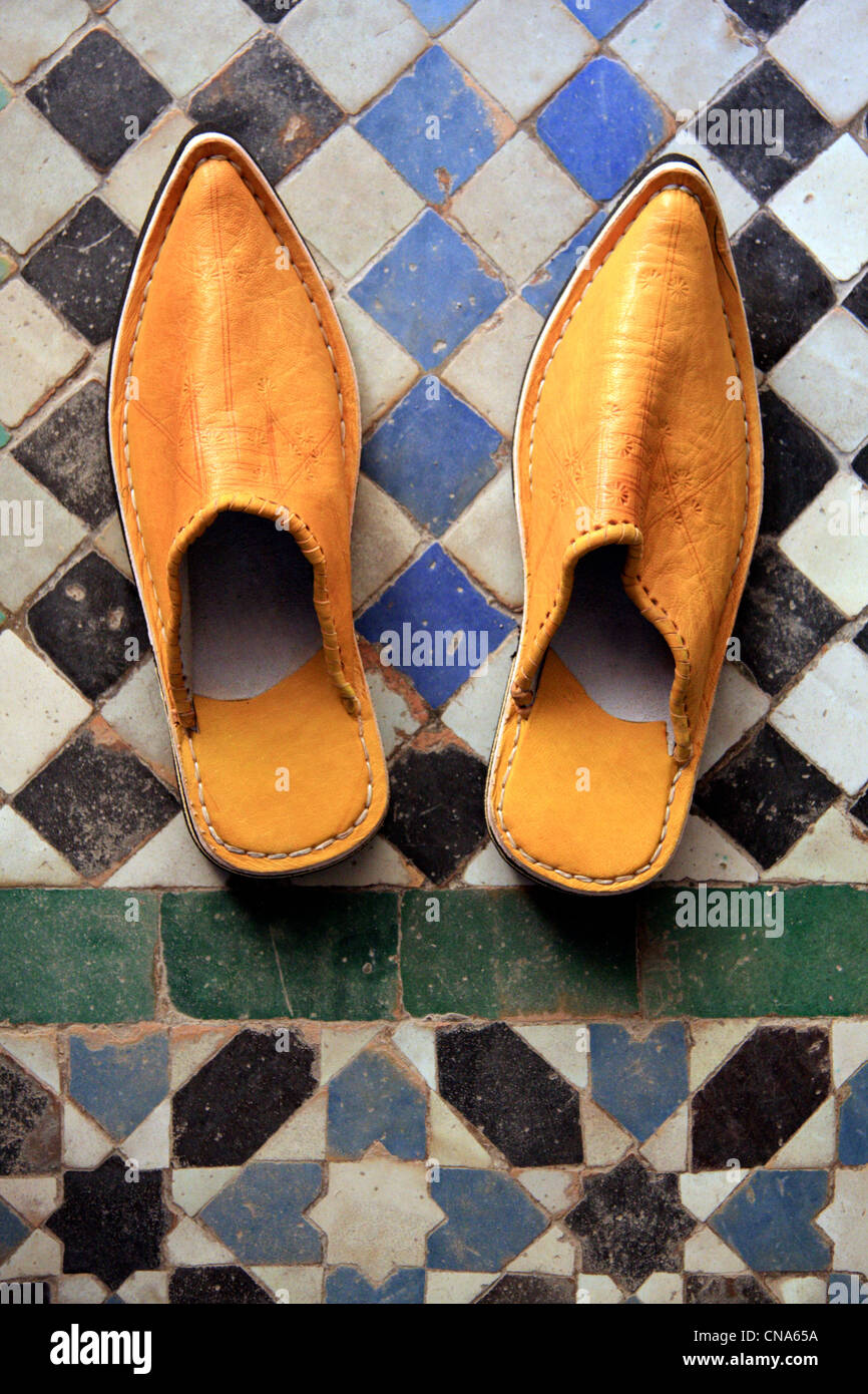 Pair traditional Moroccan slippers/babouches/shoes & traditional tile work (zellij), Marrakech, Morocco Stock Photo