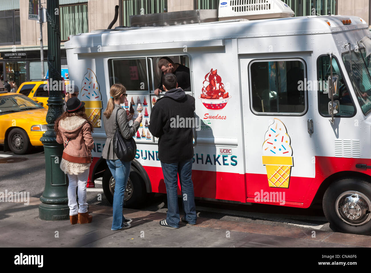 An ice cream truck vendor sells ice cream on 42nd Street in New York City Stock Photo