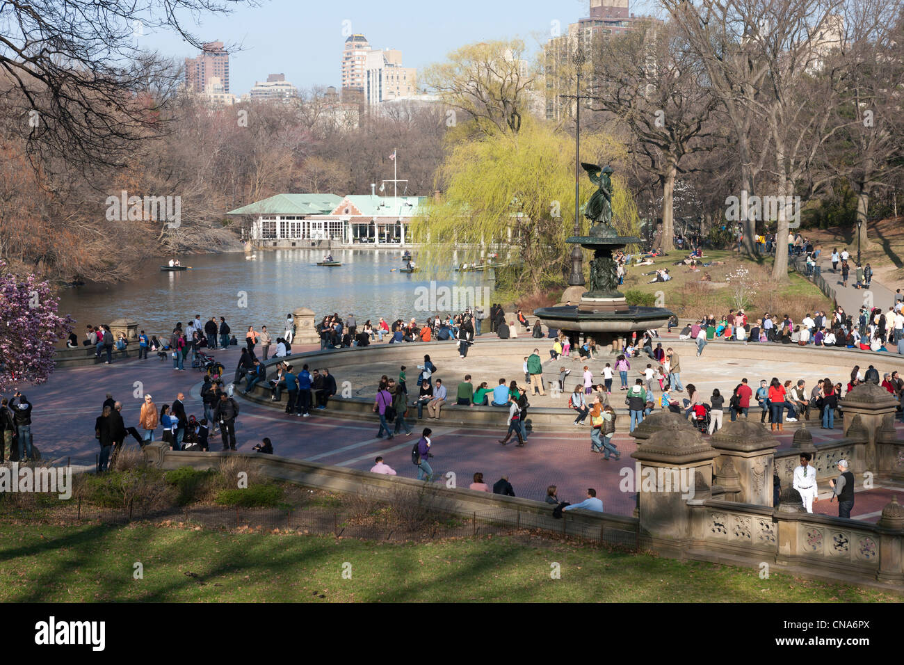 People enjoy the area around Bethesda Fountain in Central Park on a warm late winter day in New York City. Stock Photo