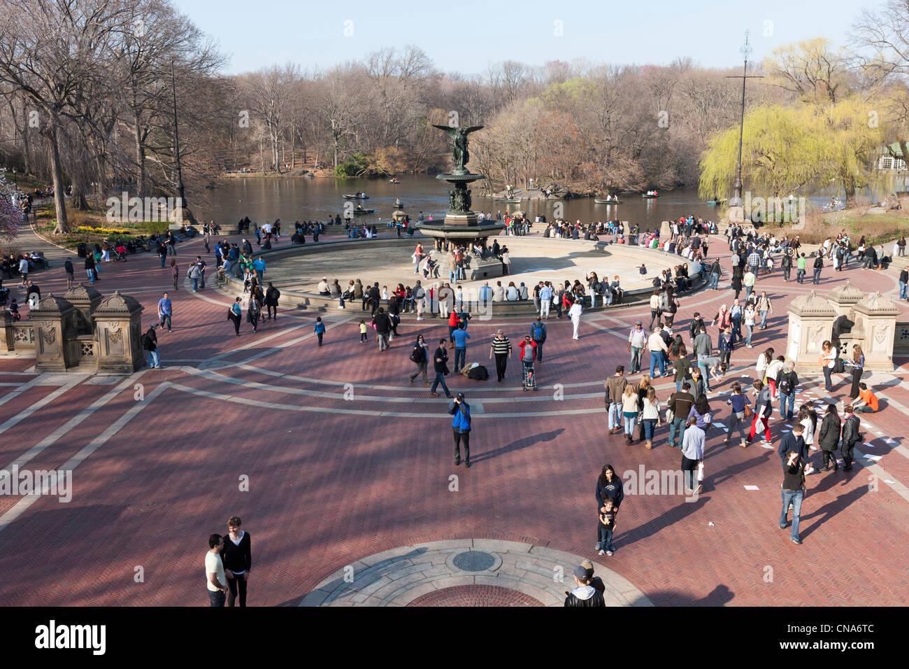 People enjoy the area around Bethesda Fountain in Central Park on a warm late winter day in New York City. Stock Photo