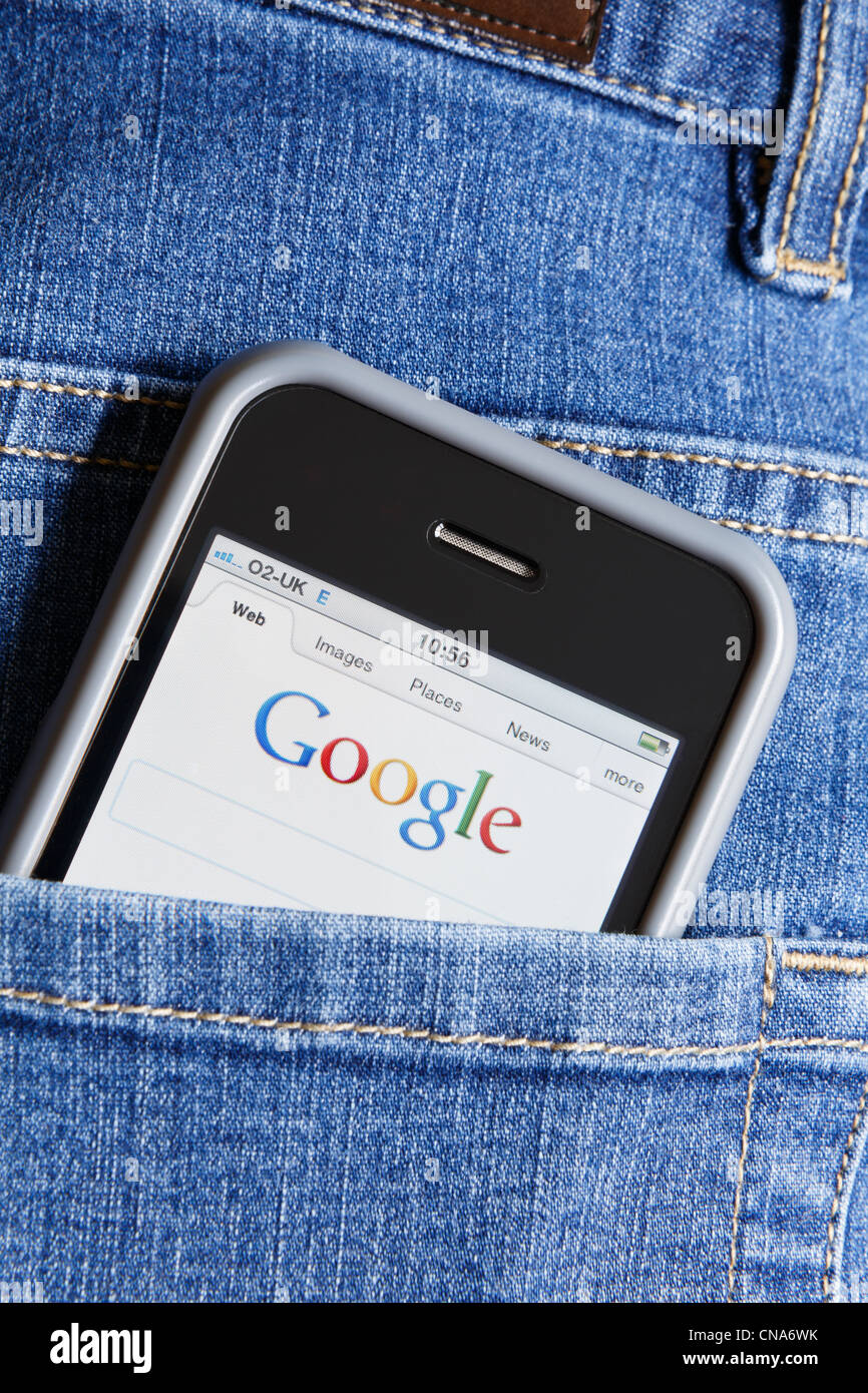 A handy Apple iPhone displaying Google search engine in the back pocket of a pair of blue denim jeans. Go anywhere concept. Digital footprint. UK Stock Photo