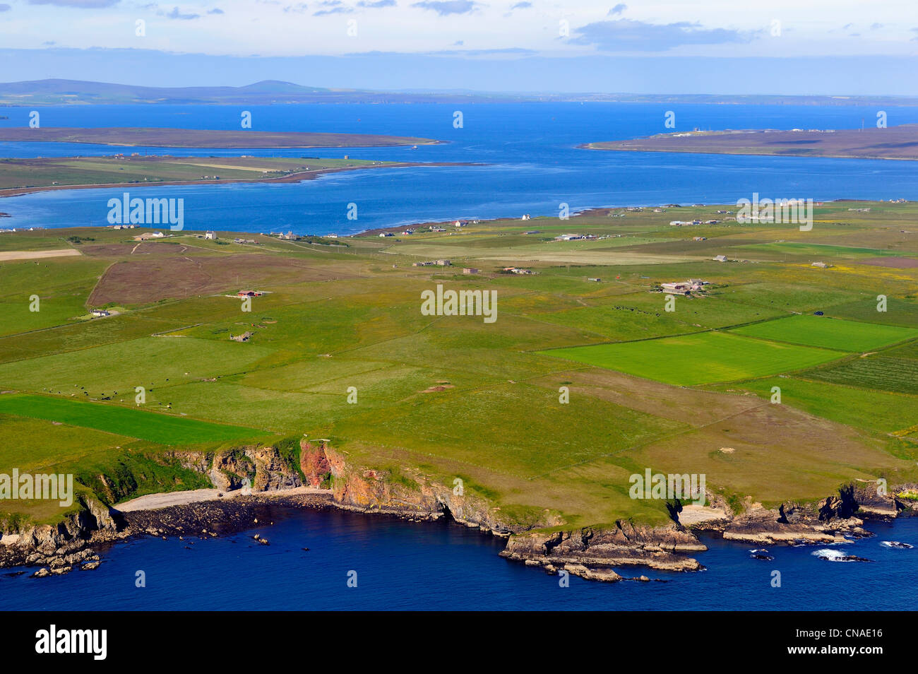 United Kingdom, Scotland, Orkney Islands, fields and scattered farms on the peninsula of South Walls (Hoy) in front of Scapa Stock Photo