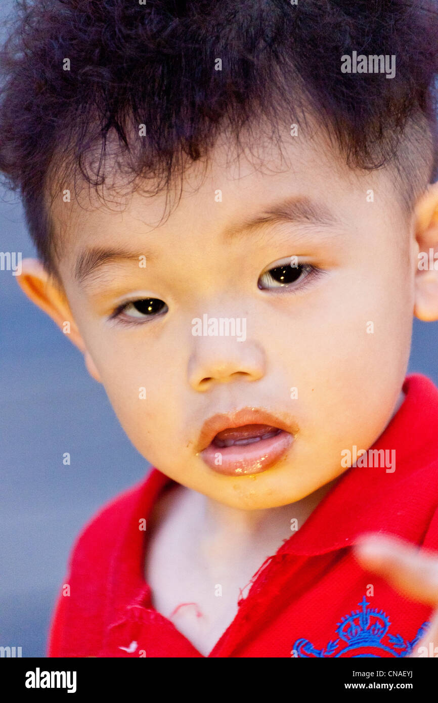 Young local Taiwanese boy in red shirt, Itashao, Taiwan. JMH5887 Stock Photo