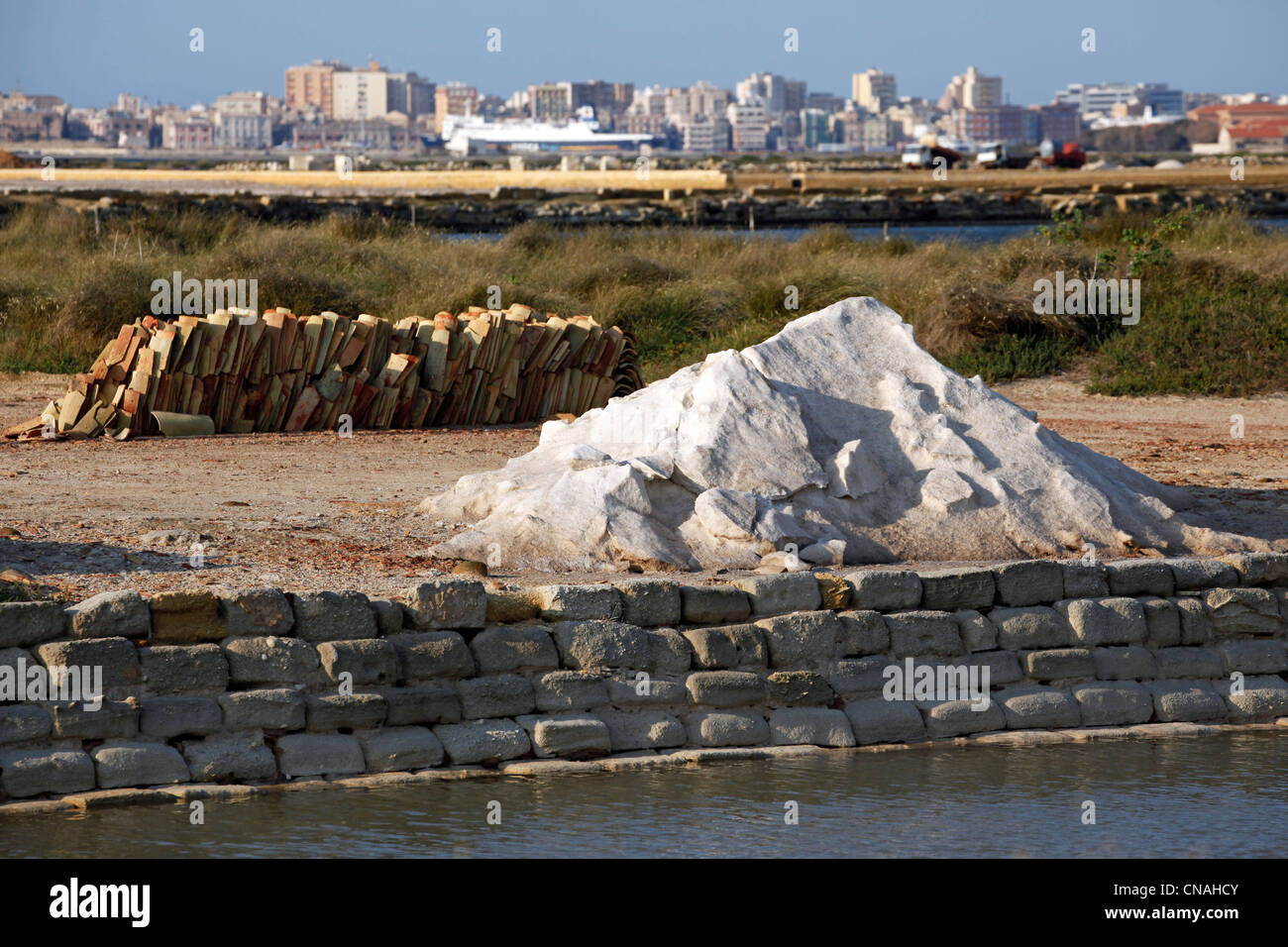Piles of salt stored in the Salt Pans in Trapani, Sicily, Italy Stock Photo
