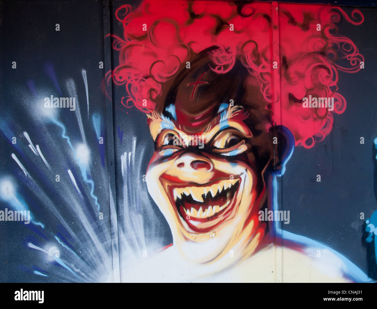 Graffiti spray painted onto the side of wooden boardings surrounding a building site in Portsmouth city centre Stock Photo