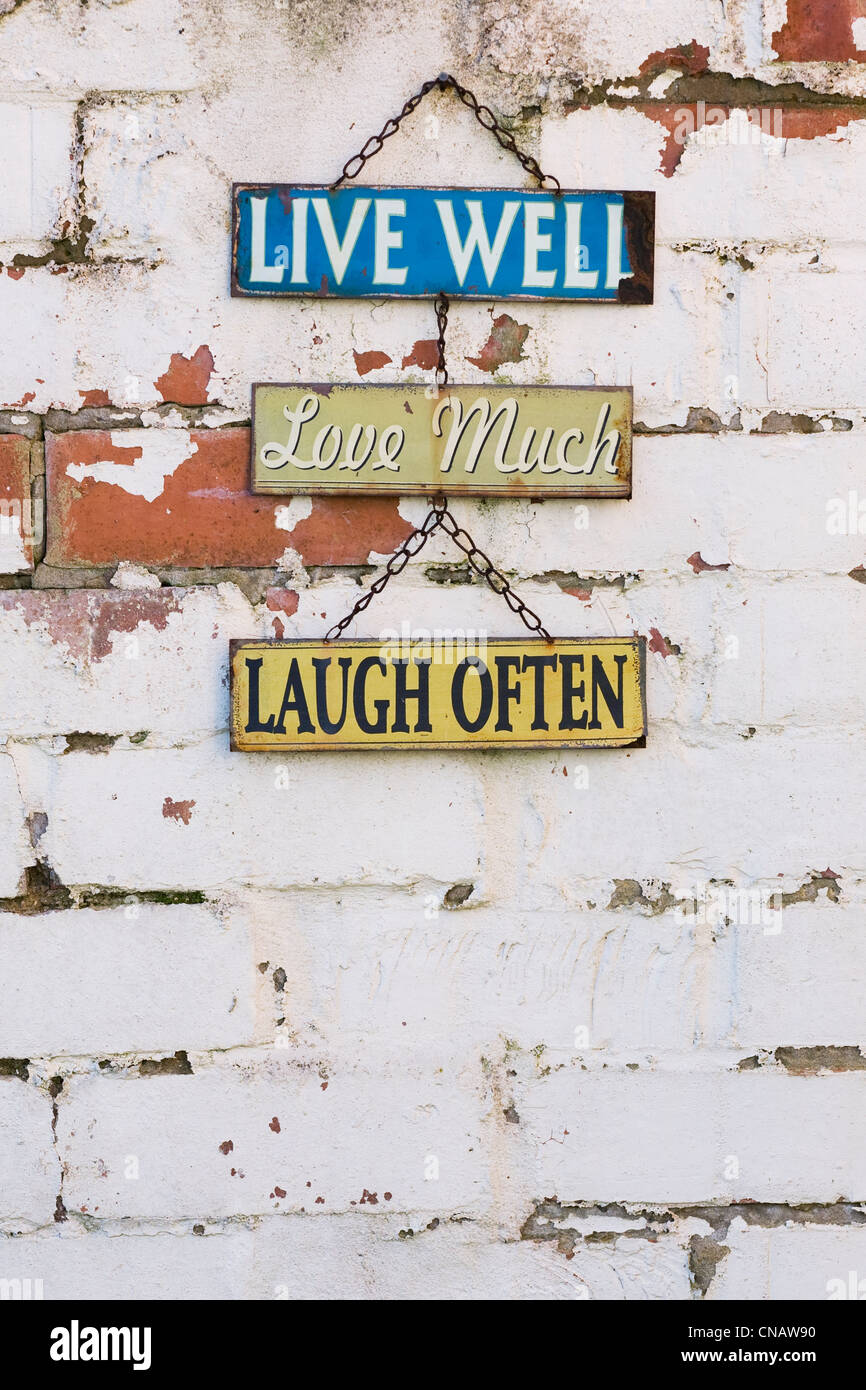 Live, Love, Laugh sign on an old brick wall. Stock Photo
