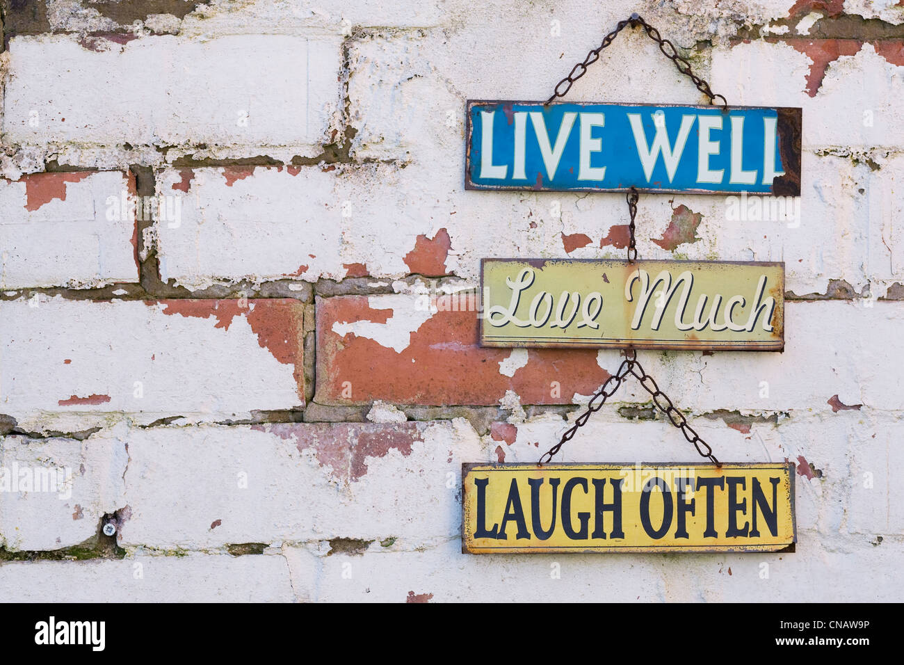 Live, Love, Laugh sign on an old brick wall. Stock Photo